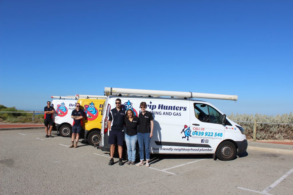 Drip Hunters team of plumbers in Perth standing in front of their van